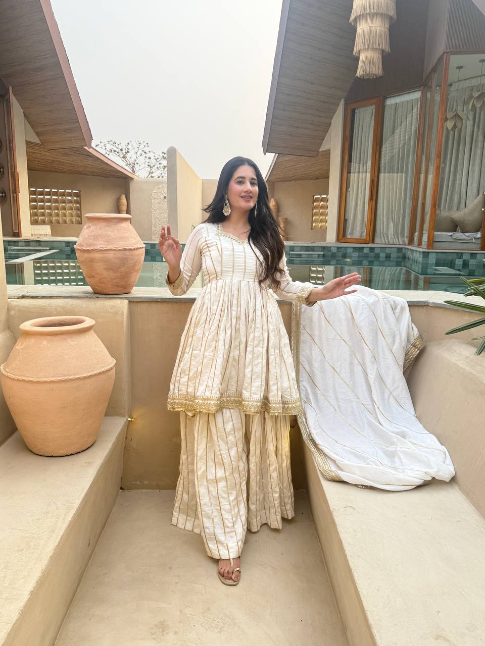 Radiant Rose Pink Flared Peplum Kurti and Sharara Set Embellished with Luminous Gold Zari Stripes and Sequined Borders
